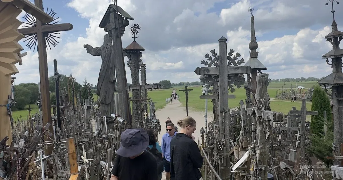 Berg der Kreuze, Litauen — Holzsteg mit Jesus-Statue und handgeschnitzten Kreuzen.