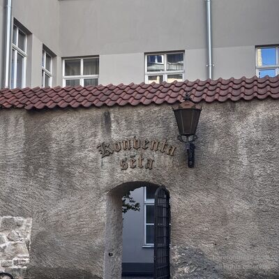 Nahaufnahme des Schildes &lsquo;Konventa sēta&rsquo; in gotischer Schrift und Laterne am Hintertor, Riga, Lettland